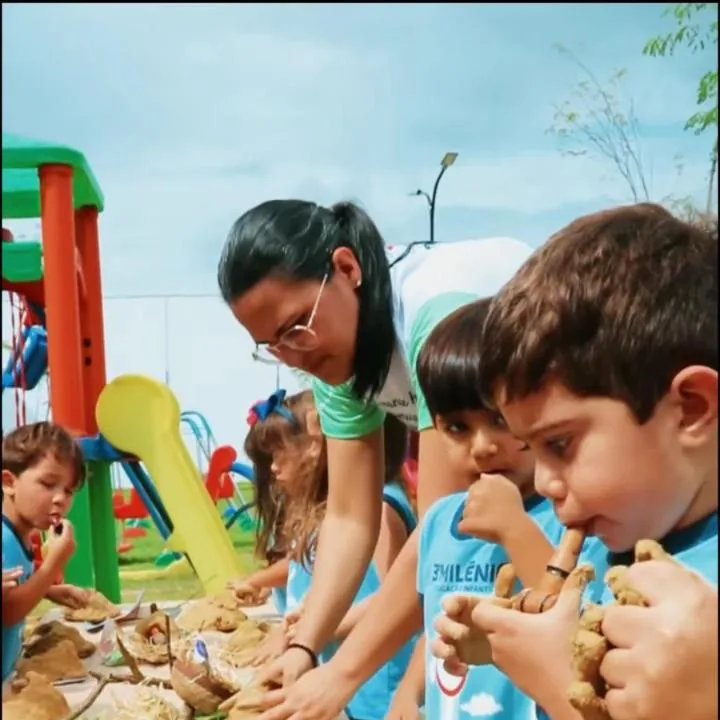 Crianças da Educação Infantil modelam argila no parquinho, na Semana da Infância