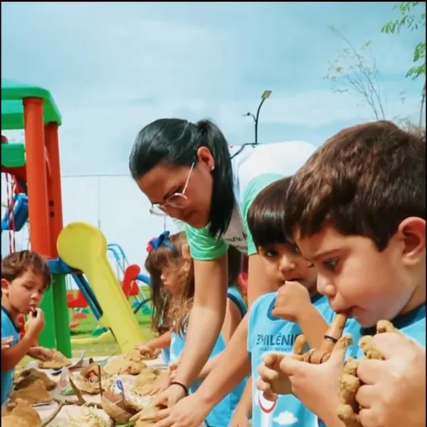 Crianças da Educação Infantil modelam argila no parquinho